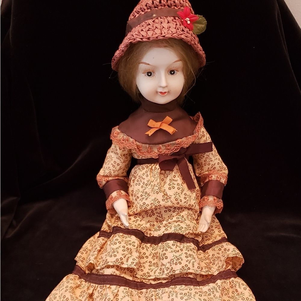 Vintage Porcelain Doll with Brown Dress and Hat